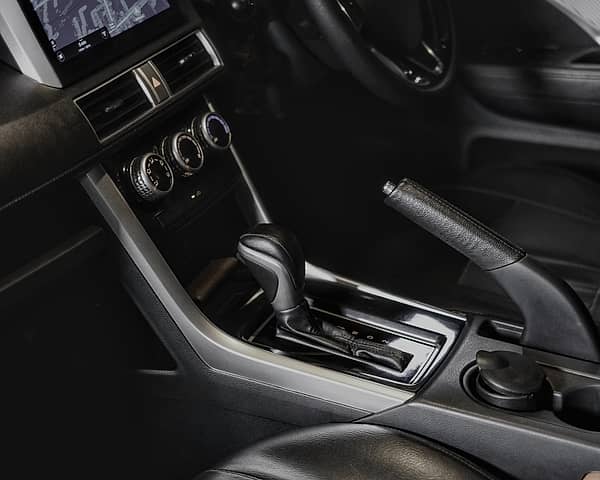 Interior of a Mitsubishi Xpander showing the automatic transmission shifter and dashboard controls from a passenger perspective.
